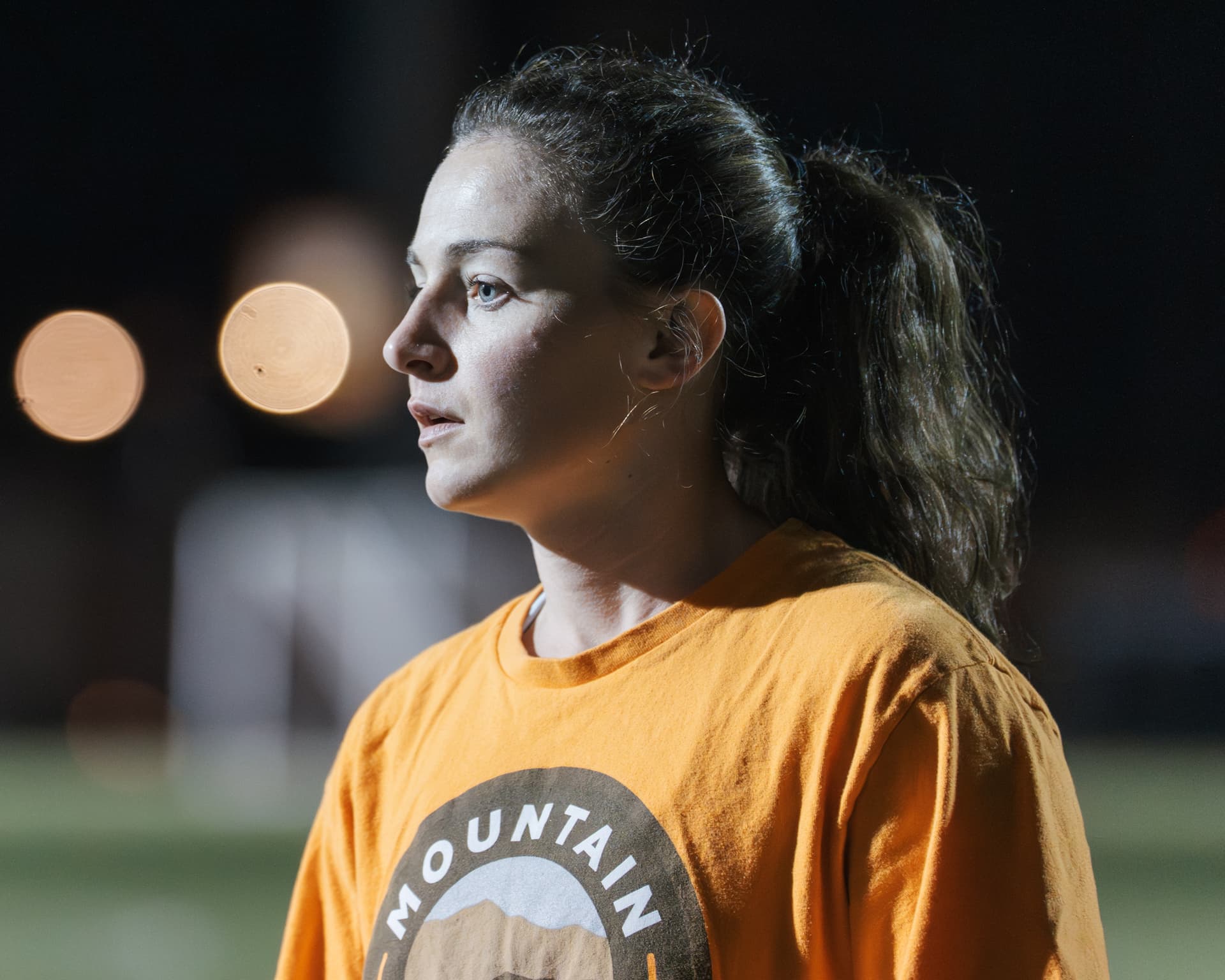 A member under the lights at a night game